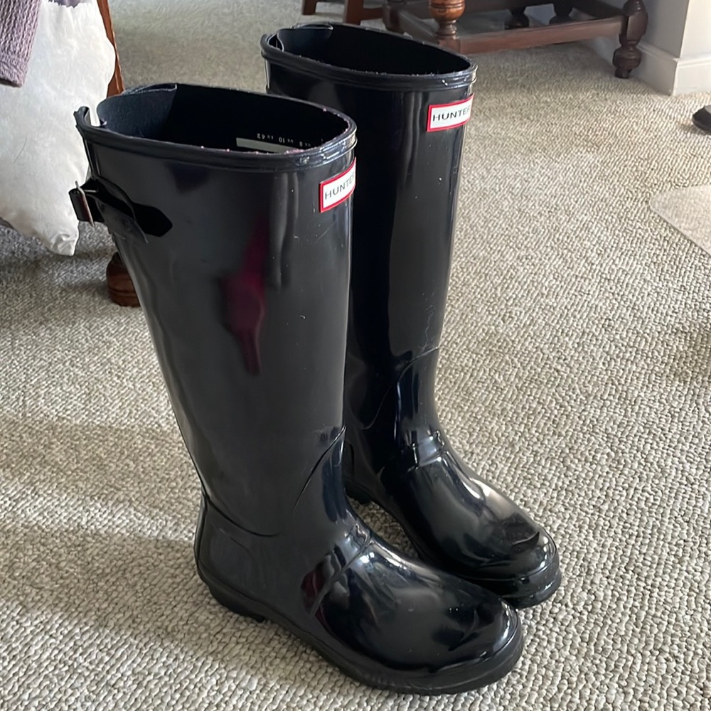 Glossy black Hunter boots with heel and sock inserts.